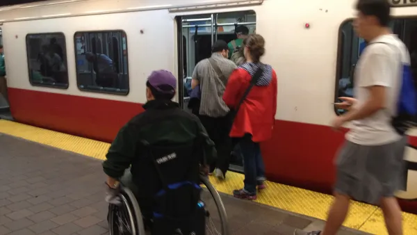Person in a wheelchair entering an inbound Red Line train at Harvard Square