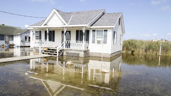 White house surrounded by several inches of tidal floodwaters.