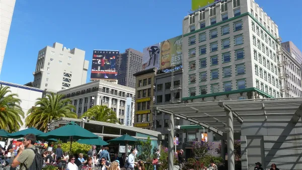 People sitting at outdoor tables with green umbrellas in Union Square, San Francisco.