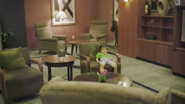 Hotel Lobby With Cute Sleeping Child