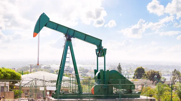 Green oil well in California neighborhood.