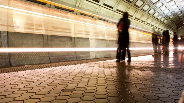 Washington DC Metro subway platform with passengers waiting and blurred train passing.
