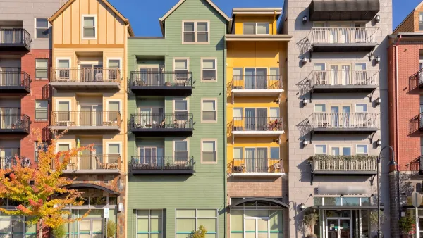 Colorful five-story condo buildings with retail on ground floor in Gresham, Oregon.