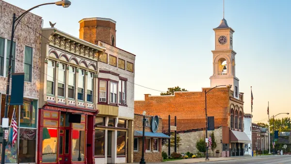 Commercial street in small rural U.S. town with storefronts and clocktower.