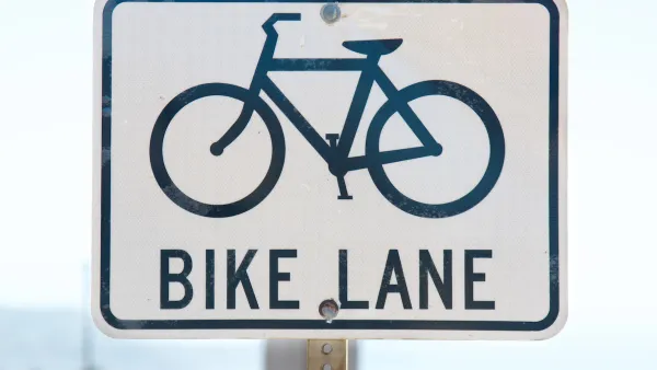 Close-up of 'bike lane' road sign with bike logo
