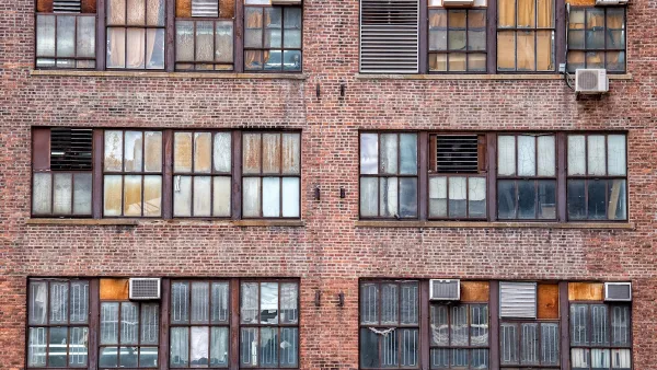 Manhattan brick apartments with AC units on windows.