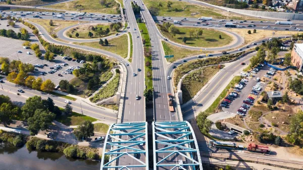 Aerial view of wide roadway and arc bridge in Denver, Colorado.