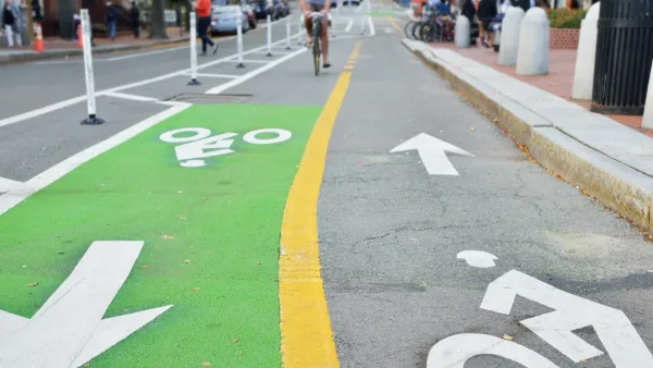 Two-way green painted bike lane in city.