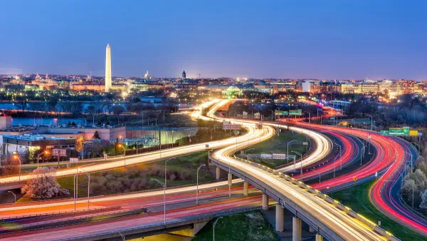 Fast-moving traffic lights on freeways in Washington, D.C. with Washington Monument in background at dusk.