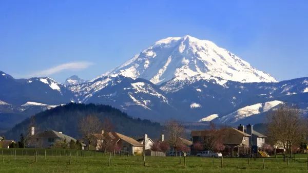 Homes in rural area with snowy Mt. Rainier in background in Washington state.