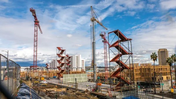Large construction site with red staircases and cranes near downtown Los Angeles, California.