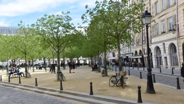 Place Dauphine plaza in Paris, France with parked bikes and people milling around.
