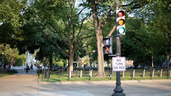 "No turn on red" sign on signpost with pedestrian stoplight.