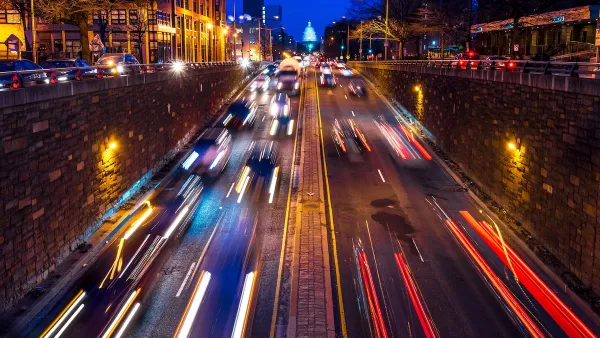 Nighttime view of blurred fast car traffic on street leading to U.S. Capitol dome in Washington, D.C.