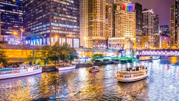 View of Chicago river and waterfront with boats at night.