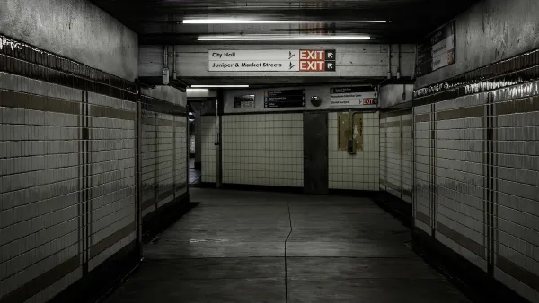 Empty hallway lined with white tile in subway station in Philadelphia, Pennsylvania.