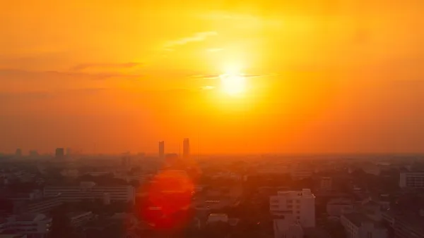 View of city skyline in red smog indicating extreme heat.