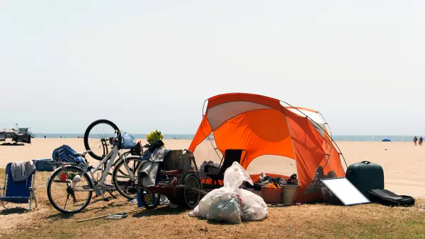 Orange tent and bicycles belonging to unhoused people at Venice Beach, California