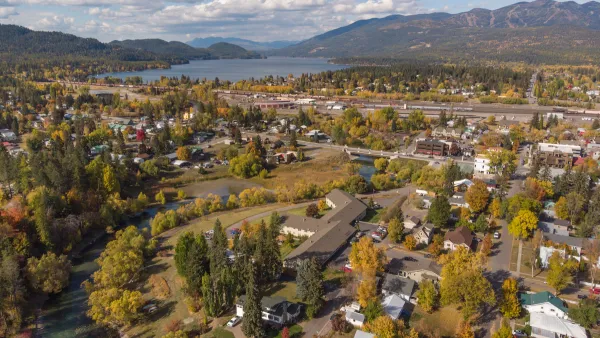 Aerial view of Whitefish, Montana with fall colors and mountains in background.