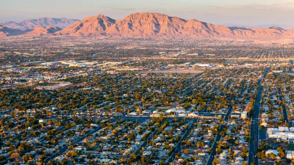 Aerial view of housingin Las Vegas, Nevada with desert mountains in background.