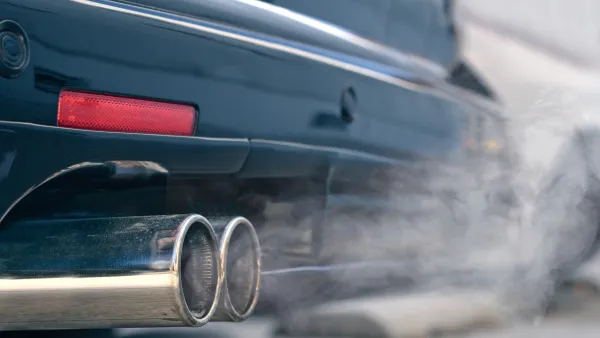 Close-up of car tailpipe emitting white smoke