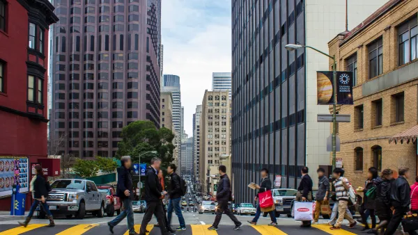People crossing street at crosswalk in downtown San Francisco, California