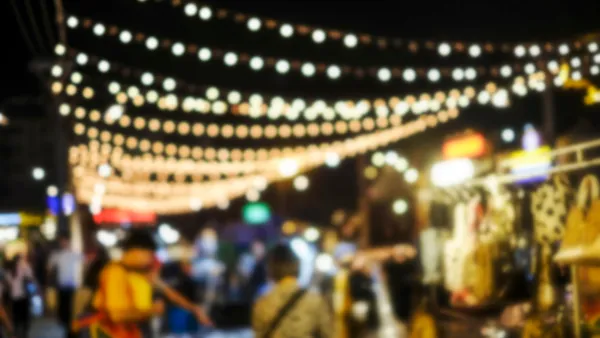 Blurred image of people shopping at night market