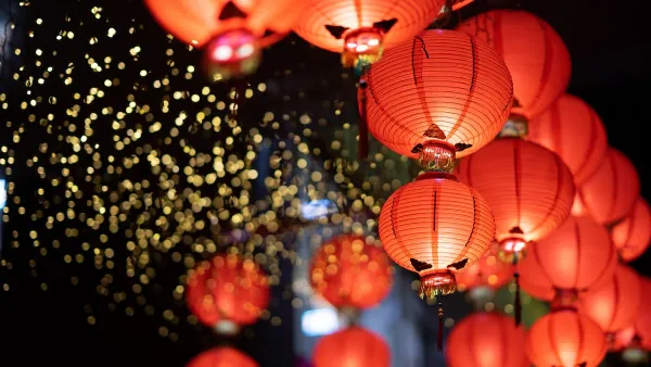 Close-up of cluster of red paper Lunar New Year lanters at night.