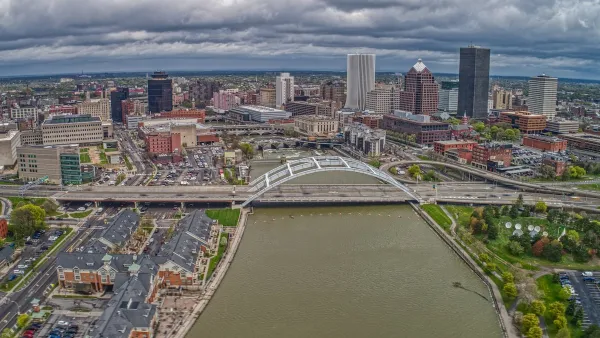Aerial view of downtown Rochester, New York with river and bridge in foreground.