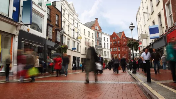Pedewstrianized street paved with red bricks flanked by historic four-story buildings in Dublin, Ireland