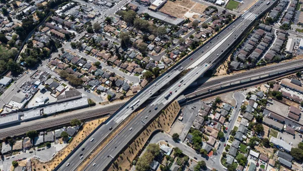 Aerial view of 238 freeway in Oakland, California cutting through neighborhood with small houses