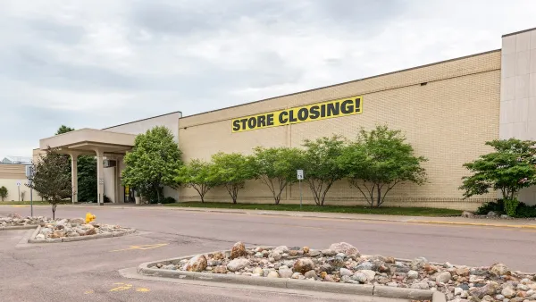 Large store in mall with yellow and black STORE CLOSING sign on front.
