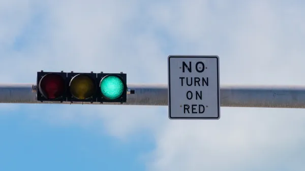Overhead traffic light with green light on and white "No turn on red" sign.