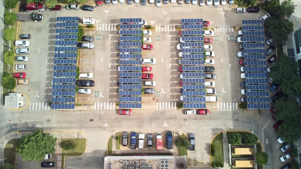 Bird's eye view of parking lot with solar panel canopies
