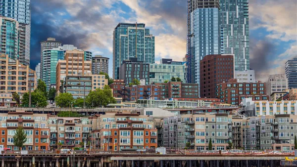 View of dense apartment buildings on Seattle waterfront with high-rise buildings in background.