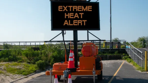 Road sign with EXTREME HEAT ALERT surrounded by orange traffic cones