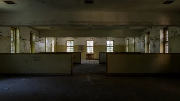 Abandoned wing of Creedmoor Hospital, Queens New York with long row of windows and 'Reading Room' visible on wall