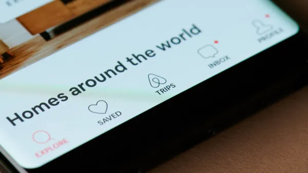 Close-up of phone screen with Airbnb app screen