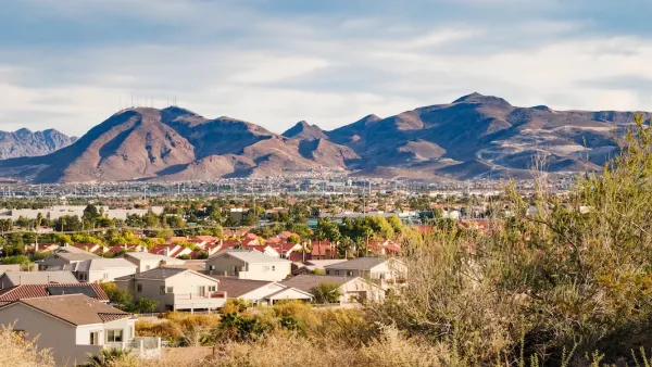 View of large homes in Henderson, Nevada with desert mountains in background.