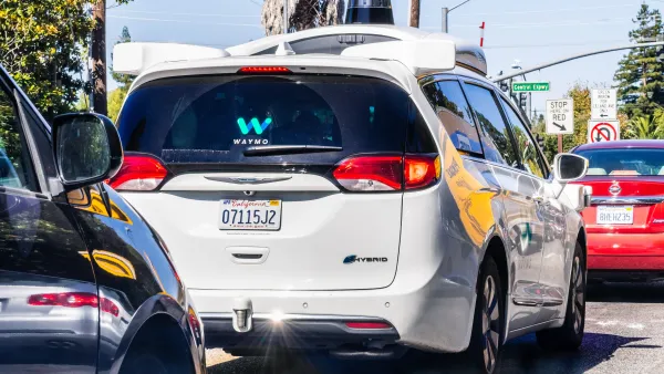 White Waymo self-driving minivan taxi on street Mountain View, California