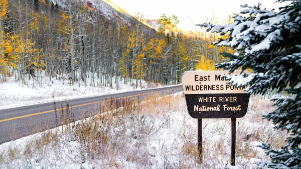 Maroon Bells sign for wilderness portal and white river national forest in Aspen, Colorado rocky mountain covered in snow after winter frozen in autumn 2019.