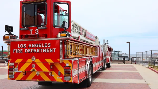 Red Los Angeles Fire Department fire truck parked on pier in San Pedro, California at Port of Los Angeles.