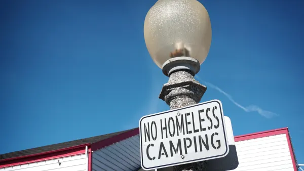 "No homeless camping" sign on a light post