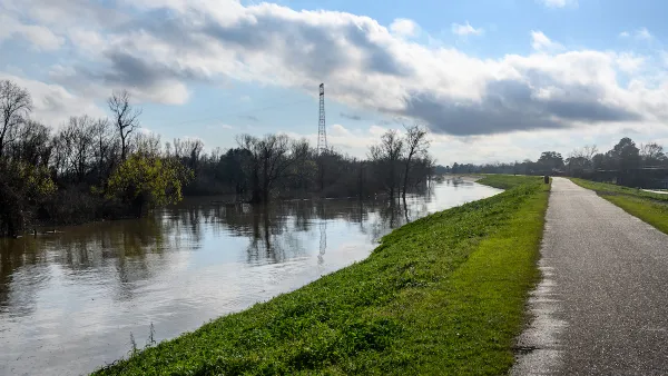 Paved bike path on top of earthen dike levee along Mississippi River in Louisiana.