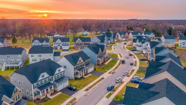 Large suburban homes on cul-de-sac in Maryland against sunset sky