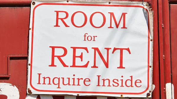Red on white 'Room for Rent, Inquire Inside' sign