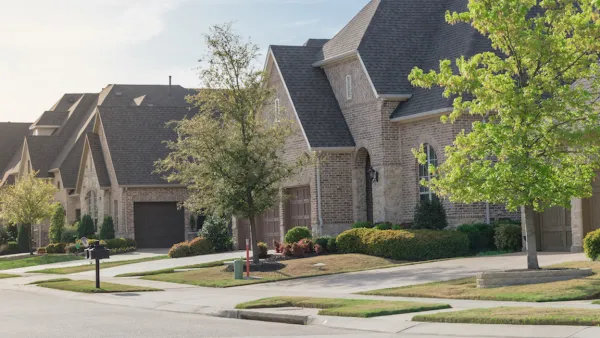 View of brick two-story houses in Dallas suburb