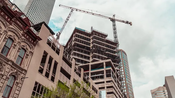 Crane and construction on multi-story buildings in downtown Houston, Texas.