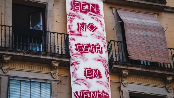 Hand painted fabric "Barcelona is not for sale" in Spanish banner hung on a building in Barcelona, Spain