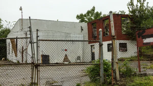 Abandoned, decaying building behind locked chain link fence in Atlanta, Georgia